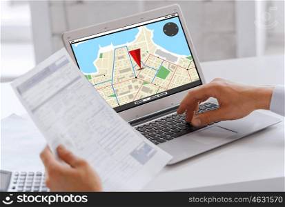 business, navigation, technology and people concept - businessman with gps navigator map on laptop computer screen working at office