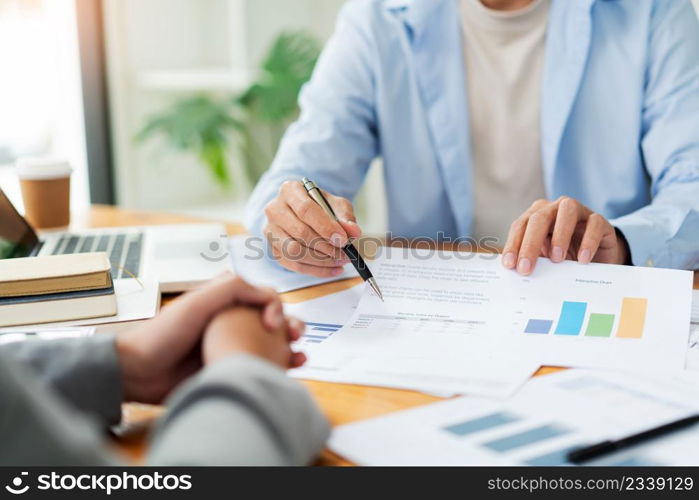 Business negotiation concept the male chattel dealer showing his information to the female realtor.