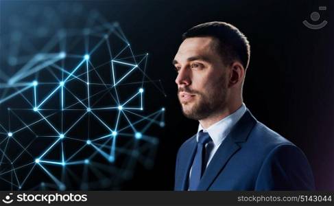 business, network and people concept - businessman in suit with virtual low poly projection over black background. businessman with low poly projection