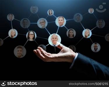 business, network, corporate and people concept - close up of businessman hand with contacts icons over dark background. close up of businessman hand with contacts icons