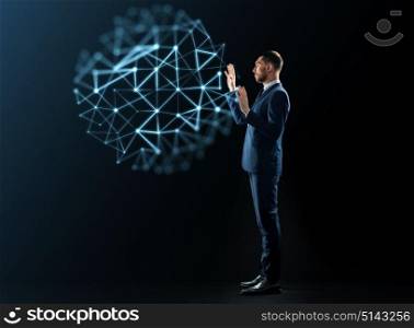 business, network, people and technology concept - businessman in suit working with virtual low poly projection over black background. businessman with virtual low poly projection