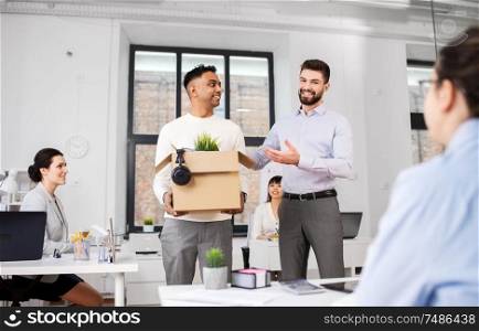 business, new job and corporate concept - indian male employee with personal stuff meeting colleagues at office. new male employee meeting colleagues at office