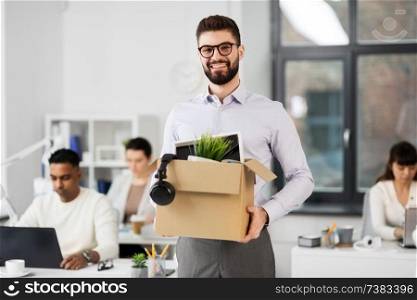 business, new job and quit concept - happy smiling male office worker with personal stuff. happy male office worker with personal stuff