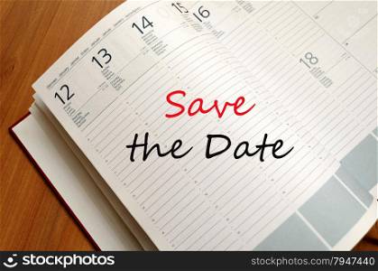Business Notepad on wooden table Save the date concept
