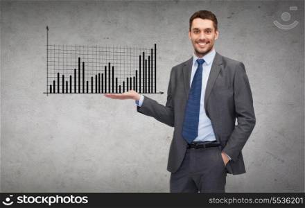 business, office, advertising and people concept - friendly young buisnessman showing growing chart on the palm of his hand