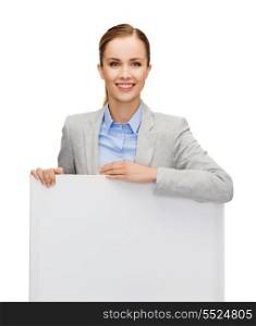 business, office and advertisement concept - smiling businesswoman with white blank board