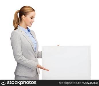 business, office and advertisement concept - smiling businesswoman with white blank board