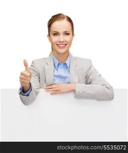 business, office and advertisement concept - smiling businesswoman with white blank board showing thumbs up