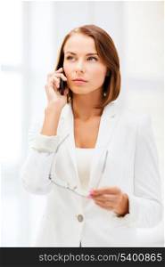 business, office and communication concept - businesswoman with smartphone in office