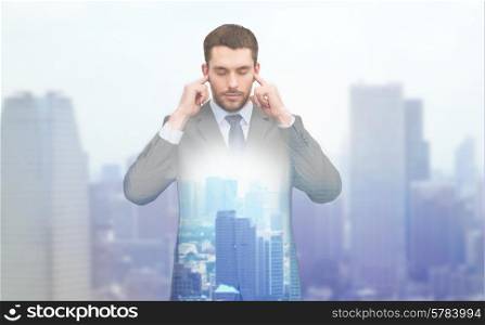 business, office and education concept - annoyed businessman covering his ears with his hands