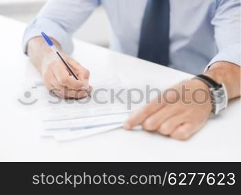 business, office, and education concept - man signing a contract