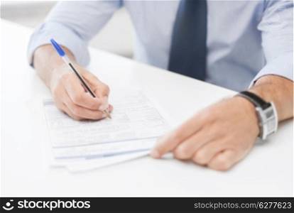 business, office, and education concept - man signing a contract