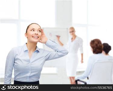 business, office and gossip concept - smiling businesswoman listening gossig at office