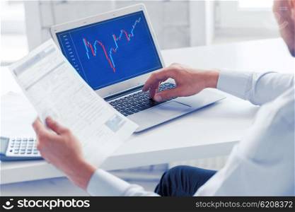 business, office and money concept - businessman working with forex chart and papers in office