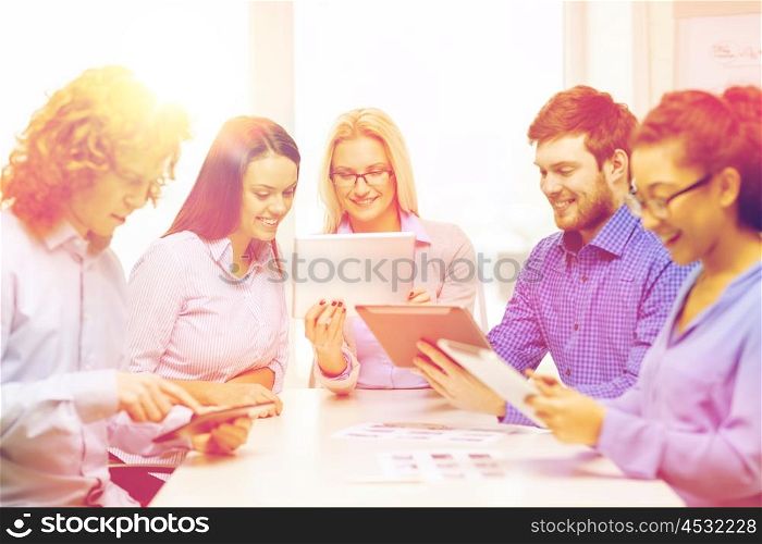 business, office and startup concep - smiling creative team with table pc computers and papers working in office