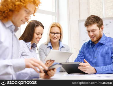 business, office and startup concep - smiling creative team with table pc computers and papers working in office