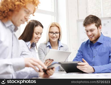 business, office and startup concep - smiling creative team with table pc computers and papers working in office