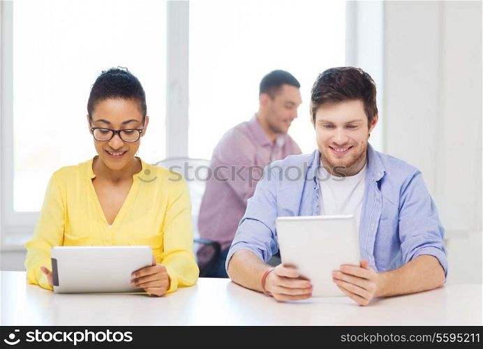 business, office and startup concept - creative smiling team with tablet pc computers at office