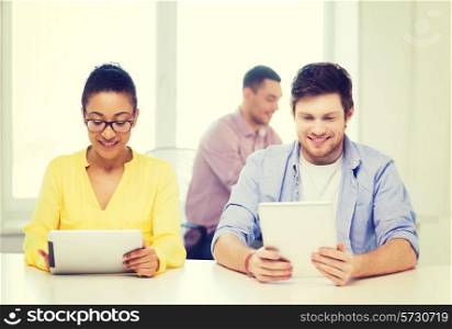 business, office and startup concept - creative smiling team with tablet pc computers at office
