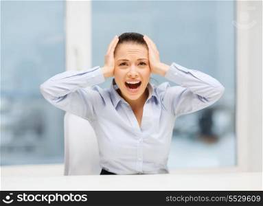 business, office and stress concept - angry screaming businesswoman in office