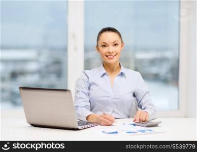 business, office and tax concept - smiling businesswoman working with documents in office