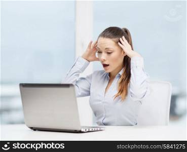 business, office and technology concept - stressed businesswoman with laptop at work