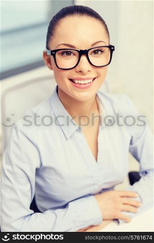 business, office and vision concept - smiling businesswoman in eyeglasses in office
