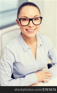 business, office and vision concept - smiling businesswoman in eyeglasses in office