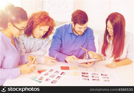 business, office, architecture and startup concept - smiling creative team with color samples and blueprint at office