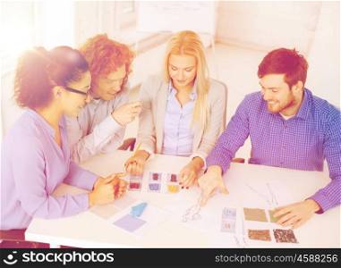 business, office, clothes design and starup concept - smiling creative team looking at sketch