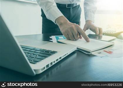 Business, office concept. businessman working with digital tablet and laptop with financial business document.