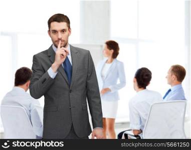 business, office, gesture and people concept - group of businessmen making hush sign in office