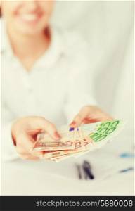 business, office, household, banking, tax, gambling concept - woman hands with euro cash money
