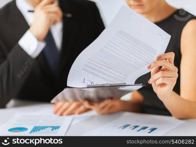 business, office, law and legal concept - picture of man and woman hand signing contract paper