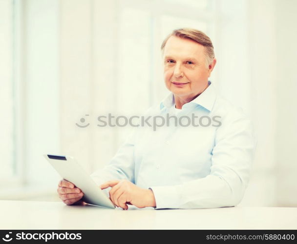 business, office, oldness, school and education concept - old man wearing eyeglasses with tablet computer at home