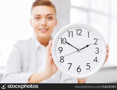 business, office, school and education concept -attractive businesswoman showing clock