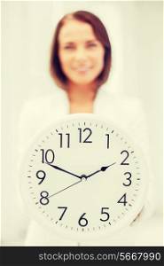 business, office, school and education concept - attractive businesswoman showing clock