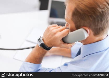 business, office, school and education concept - businessman talking on the phone