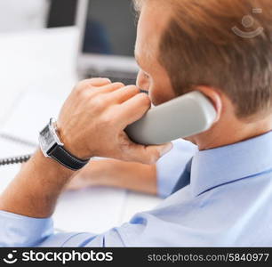 business, office, school and education concept - businessman talking on the phone