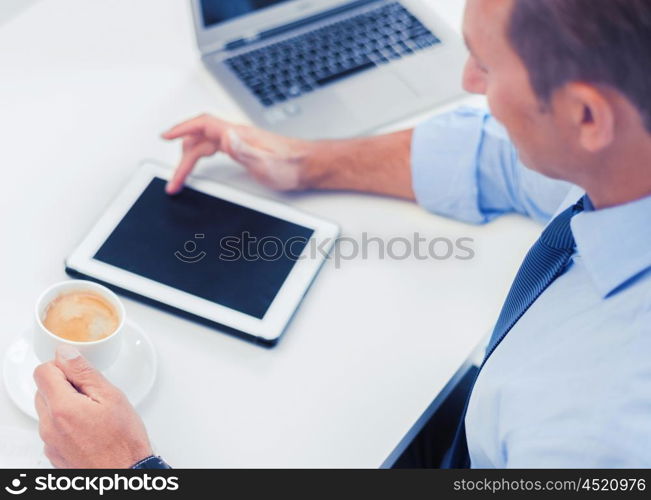 business, office, school and education concept - businessman with tablet pc drinking coffee in office