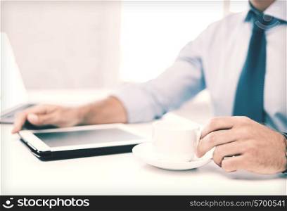business, office, school and education concept - businessman with tablet pc drinking coffee in office