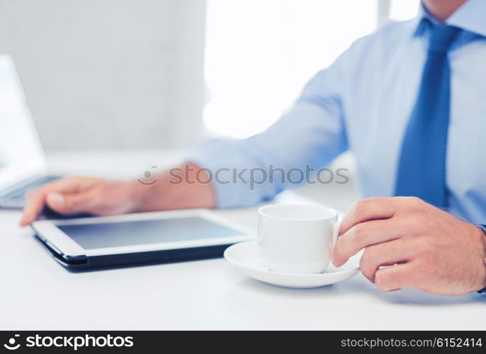 business, office, school and education concept - businessman with tablet pc drinking coffee in office