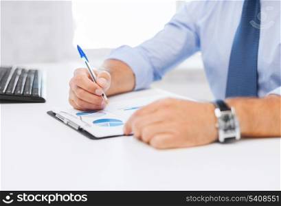business, office, school and education concept - businessman working and signing papers