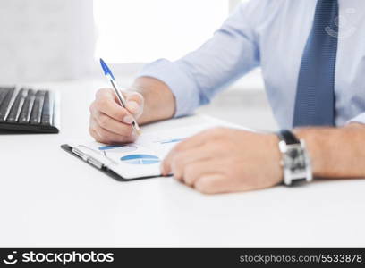 business, office, school and education concept - businessman working and signing papers