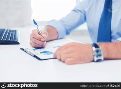 business, office, school and education concept - businessman working and signing papers