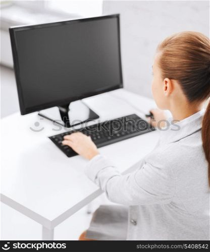 business, office, school and education concept - businesswoman on computer with blank screen in office