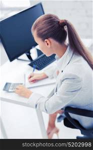 business, office, school and education concept - businesswoman with notebook and calculator. businesswoman with notebook and calculator