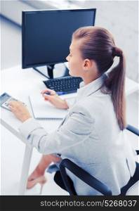 business, office, school and education concept - businesswoman with notebook and calculator. businesswoman with notebook and calculator