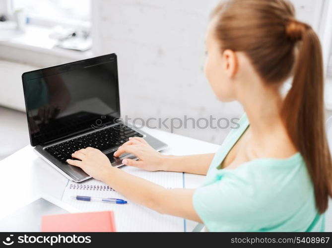 business, office, school and education concept - businesswoman working on laptop with blank screen