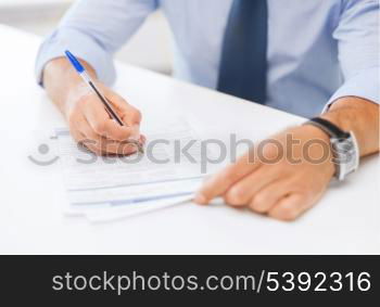 business, office, school and education concept - man signing a contract